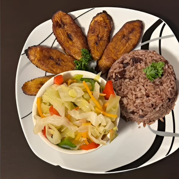 Island Grill AZ Jamaican meal with fried plantains, rice and peas, and steamed cabbage.